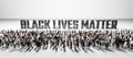 People in front of Black lives matter slogan