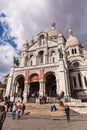 People in front of Sacre Coeur, Famous Church Landmark in Paris France