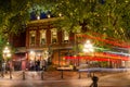 People in front of the Statue of Grassy Jack in Gastown, Vancouver, at Night.