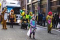 People in fun costumes celebrating at the carnival Fasching on Rose Monday parade in the city