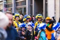 People in fun costumes celebrating at the carnival Fasching on Rose Monday parade in the city