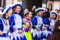 People in fun costumes celebrating at the carnival Fasching on Rose Monday parade in the city