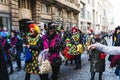 People in fun costumes celebrating at the carnival Fasching on Rose Monday parade in the city