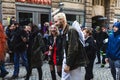 People in fun costumes celebrating at the carnival Fasching on Rose Monday parade in the city