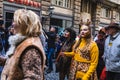 People in fun costumes celebrating at the carnival Fasching on Rose Monday parade in the city