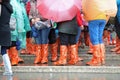 people with gaiters and rainproof raincoats and umbrellas Royalty Free Stock Photo