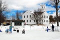 People gather on a frozen pond to ice skate and play hockey