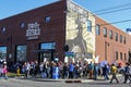 People gather by mural on that says This Machine Kills Fascists at Woody Guthrie Center at Womens March in Tulsa Oklahoma USA 1-20