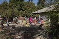 People gather near a house in a slum in the outskirts of the city of Gabu, with dirt in the street and vultures, in Guinea-Bissau