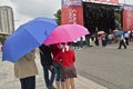People gather together under rainy weather at Thomson Memorial Park, Toronto, watching the Canada Day performances