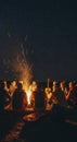 People gathered around a burning fire Royalty Free Stock Photo