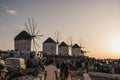 People gathering near windmills to watch sunset in Mykonos Town, Mykonos, Greece