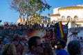 People gathering with rainbow flags in the street in gay pride day in Torremolin