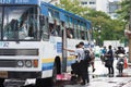 People getting on bus after the rain