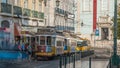 People getting on the tram , at a station in Luis de Camoes square