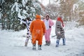 4 people, 2 girls and 2 mens with beard in kigurumi in snow winter forest. Pajama costume pig cow kangaroo and cat. Fun with Royalty Free Stock Photo