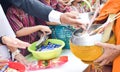 People give alms to a Buddhist Thai monk on morning Royalty Free Stock Photo