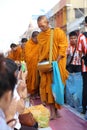 People give food offerings to monks