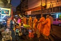 People giving alms to buddhist monks