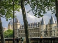 People go along Seine riverside near Palace Conciergerie