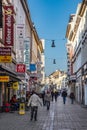 people go shopping at Faulbrunnenstrasse - engl: rotten fountain street - with historic 19th century facades downtown Wiesbaden