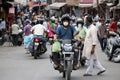 People going on the scooter wearing mask