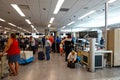 People going through TSA security screening a busy international airport