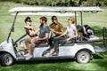 People in the golf car on the playing course Royalty Free Stock Photo