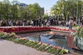 People at the grave of the Unknown soldier with the eternal flame in the Alexander Garden on Victory Day. Moscow,