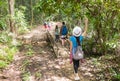People Group With Backpacks Trekking On Forest Path Back Rear View Walk On Bridge, Mix Race Young Men And Woman On Hike