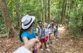People Group With Backpacks Trekking On Forest Path Holding Hands Helping, Mix Race Young Men And Woman On Hike Tourists Royalty Free Stock Photo