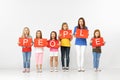 People. Group of children with red banners isolated in white Royalty Free Stock Photo