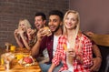 People Group Eating Fast Food Burgers Sitting At Wooden Table In Cafe Royalty Free Stock Photo