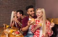 People Group Eating Fast Food Burgers Sitting At Wooden Table In Cafe Royalty Free Stock Photo