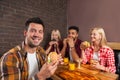 People Group Eating Fast Food Burgers Sitting At Wooden Table In Cafe Royalty Free Stock Photo