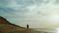 People group standing beach landscape. Family walking sunset sea by waves crash. Royalty Free Stock Photo