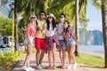 People Group Take Selfie With Action Camera On Stick While Walking In Palm Tree Park On Beach, Happy Smiling Mix Race