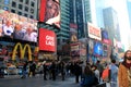 People grouped together along the street, with bright and colorful marquees,Times Square,NYC 2015