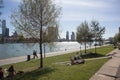 People in groups relaxing and socialising in an urban waterfront setting