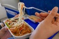 People hand having a meal on airplane flight.