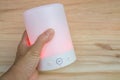 People hand hold glow pink modern wireless speaker with left hand for music player