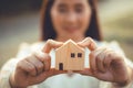 people hand holding miniature wooden house model for banking housing mortgage real estate rent lease home family concept Royalty Free Stock Photo