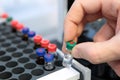 People hand holding a test tube vial sets for analysis in the gas liquid chromatograph. Laboratory assistant inserting laboratory Royalty Free Stock Photo