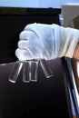 People hand holding a test tube vial sets for analysis in the gas liquid chromatograph. Laboratory assistant inserting laboratory