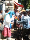 People handing out water to a thirsty crowd