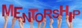 People Hands Holding Red Word Mentorship Blue Sky Royalty Free Stock Photo