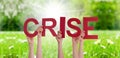 People Hands Holding Word Crise Means Crisis, Grass Meadow Royalty Free Stock Photo