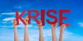 People Hands Holding Word Krise Means Crisis, Blue Sky Royalty Free Stock Photo