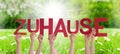People Hands Holding Word Zuhause Means Home, Grass Meadow Royalty Free Stock Photo