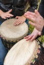 People hands playing music at djembe drums Royalty Free Stock Photo